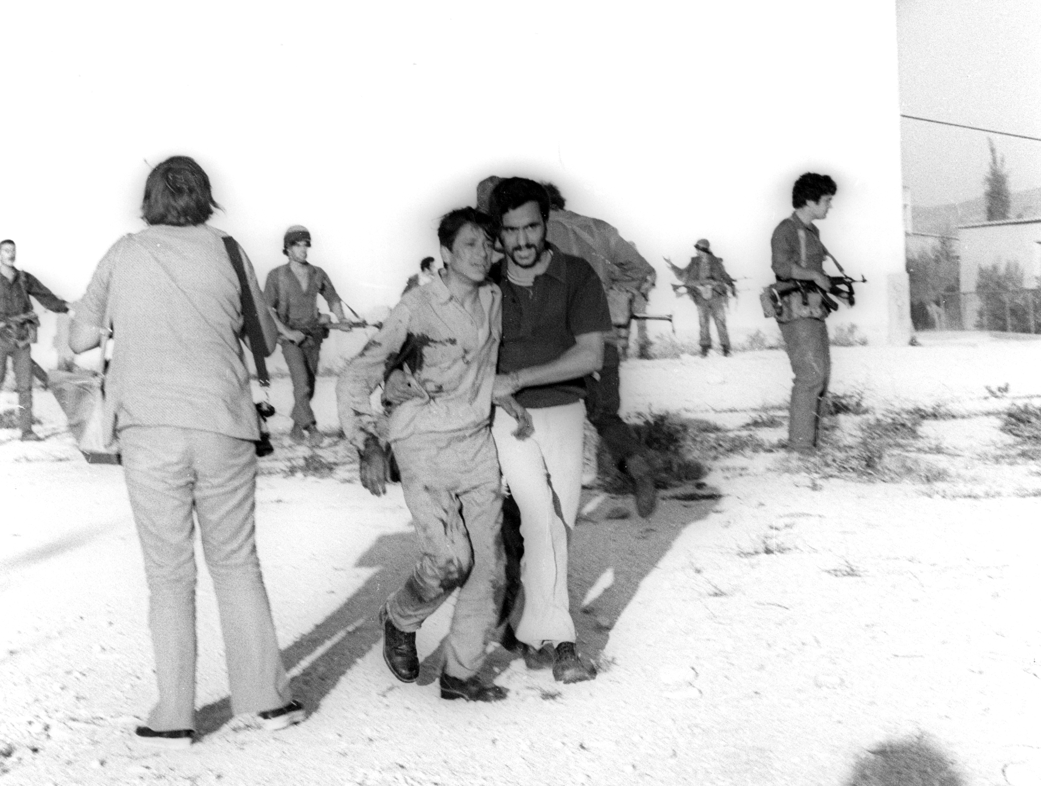 An Arab terrorist group attacked a school at Maalot killing several children and wounded thenth of them. IDF attacked the group killing the terrorists. Photo shows: Soldier rescue the wounded children from the school 1974/05/15 Copyright © IPPA 09239-004-02 Photo by IPPA Staff